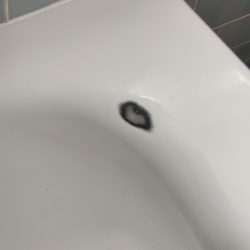 EB09 Chipped corner edge on metal bath. Alt angle